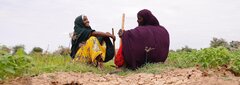 Ethiopia, Farhiya Abdi Hassan (left), a refugee from Somalia and a host community member, Ilama Rashiid Ibrahim (right) who are agriculture cooperatives beneficiaries rest in their Potatoes farm in Kobe, near Kobe refugee camp, Ethiopia.