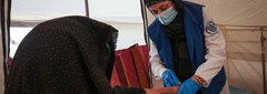 HERAT, WESTERN AFGHANISTAN, An IOM staff examines a woman injured by the devastating earthquakes in Herat.