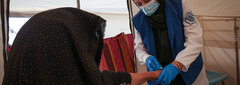 HERAT, WESTERN AFGHANISTAN, An IOM staff examines a woman injured by the devastating earthquakes in Herat.