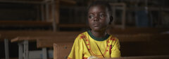 Fada, Burkina Faso, Dahani, a six-year old boy, looks out of his classroom window. After his village was attacked, Dahani and his family fled to Fada, where he started attending a remedial educational programme for out-of-school children.