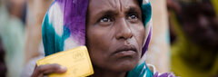 Mogadishu, Somalia, An internally displaced Somali woman holds her registration card while waiting for humanitarian supplies that were flown to Mogadishu.  