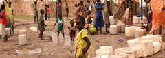 White Nile State, Refugee women and children line up for access to water in one of the refugee camps in White Nile State.