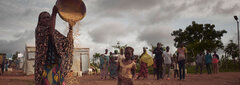 Kaya, Burkina Faso, A woman pours maize into a bowl at Tiwega 1 - the site for internally displaced people in Kaya, in Burkina Faso’s Centre-Nord Region. The site hosts 2,240 displaced people who fled insecurity in Dablo and Foubé.