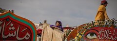 KANDAHAR, SOUTHERN AFGHANISTAN, A young Afghan girl waits for her family to receive assistance at Spin Boldak border crossing.