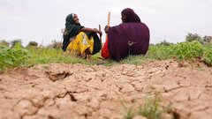 Ethiopia, Farhiya Abdi Hassan (left), a refugee from Somalia and a host community member, Ilama Rashiid Ibrahim (right) who are agriculture cooperatives beneficiaries rest in their Potatoes farm in Kobe, near Kobe refugee camp, Ethiopia.