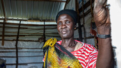 Malakal County, Upper Nile State, A returnee woman who fled violence in Sudan standing in temporary shelter in a transit site.