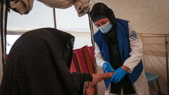 HERAT, WESTERN AFGHANISTAN, An IOM staff examines a woman injured by the devastating earthquakes in Herat.