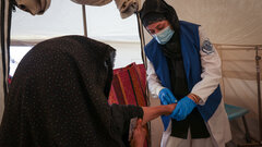 HERAT, WESTERN AFGHANISTAN, An IOM staff examines a woman injured by the devastating earthquakes in Herat.