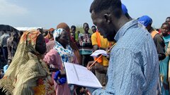 Renk County, Upper Nile State, South Sudan, A humanitarian worker recording details of South Sudanese returnees at Joda point of entry in Renk County in Upper Nile State. 