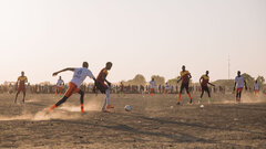 Rubkona County, Unity State, Youth play football at the buffer zone in Bentiu IDP camp sector 5, southern gate.