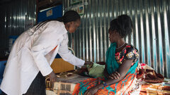 Malakal PoC site, Upper Nile State, South Sudan, A health worker screening a child for malnutrition.