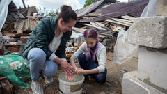 Chernihiv, Ukraine, Nine-year-old Veronika and her family have been living with friends since March 2022, due to the violence. Days after leaving their village, they discovered their home had been destroyed. She and her mother, Tetiana, often revisit their old home and attempt to clear the rubble.  